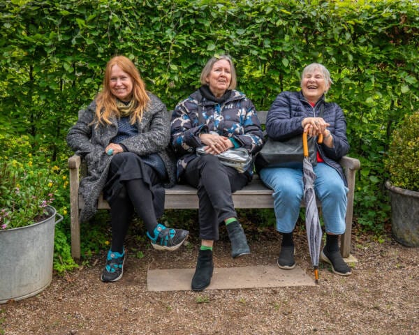 Kursister tager en pause på en bænk i Blomsterhaven